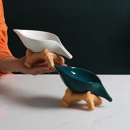 Elegant ceramic leaf-shaped soap holder with a sturdy base, adding a touch of nature-inspired sophistication to any bathroom