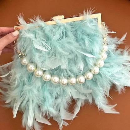 Elegant feather clutch bag with pearls and metal chains, a versatile and sophisticated evening accessory
