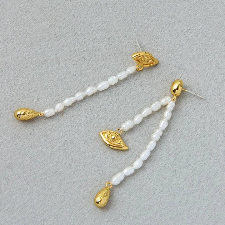 Pair of elegant, asymmetrical pearl earrings with a luxurious and sophisticated design