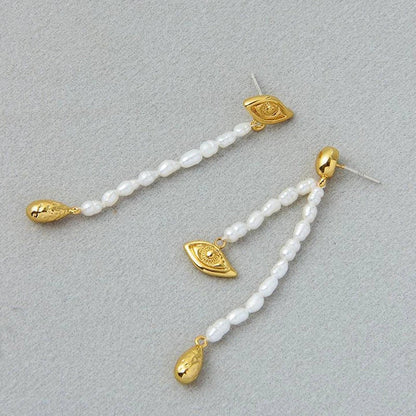 Pair of elegant, asymmetrical pearl earrings with a luxurious and sophisticated design
