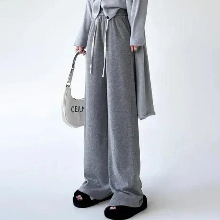 Elegant high-waist drawstring trousers in black, featuring a wide-leg cut and stylish lace-up pockets