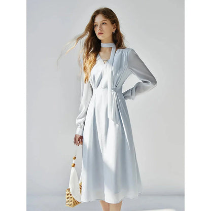 A light blue dress with a v-neck, puff sleeves, and a ribbon detail at the waist
