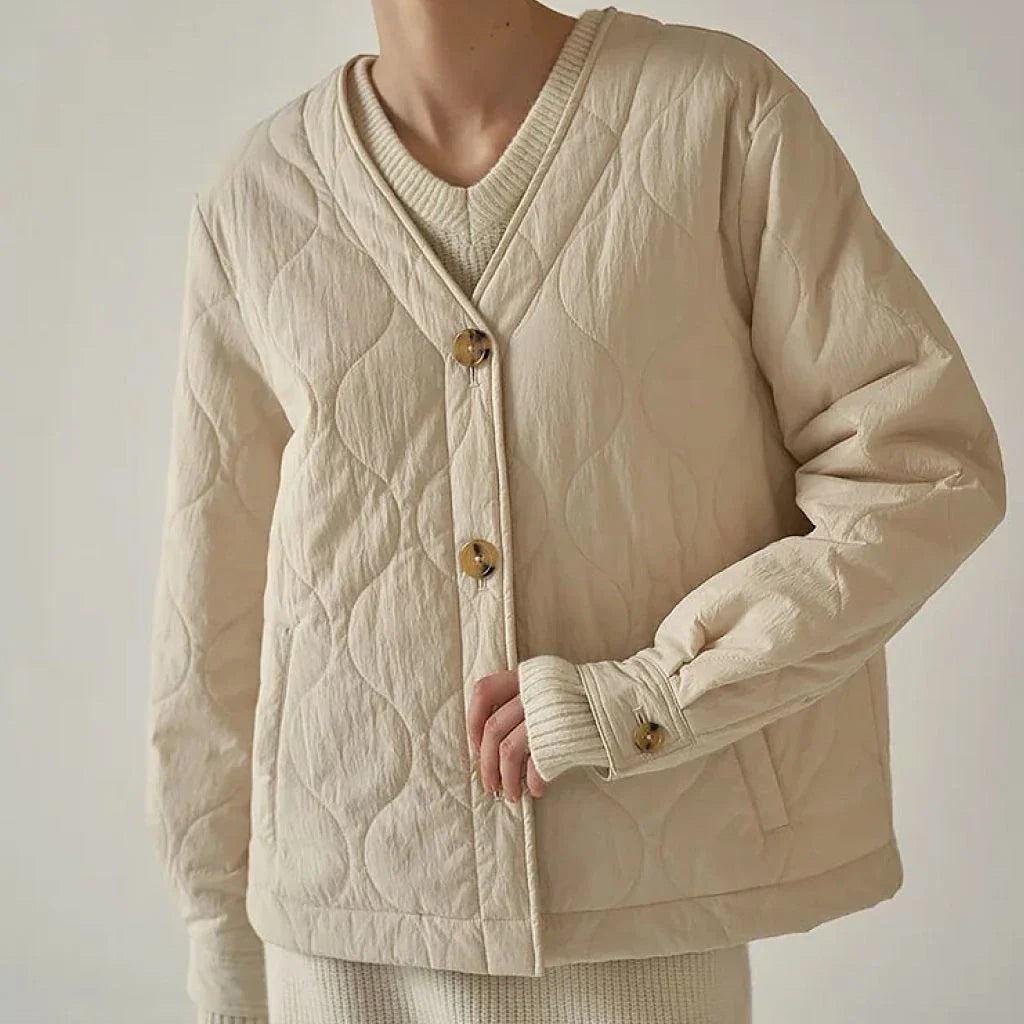 Women's quilted jacket in black, featuring a cosy v-neck collar, button detailing, and a regular fit for versatile winter style.