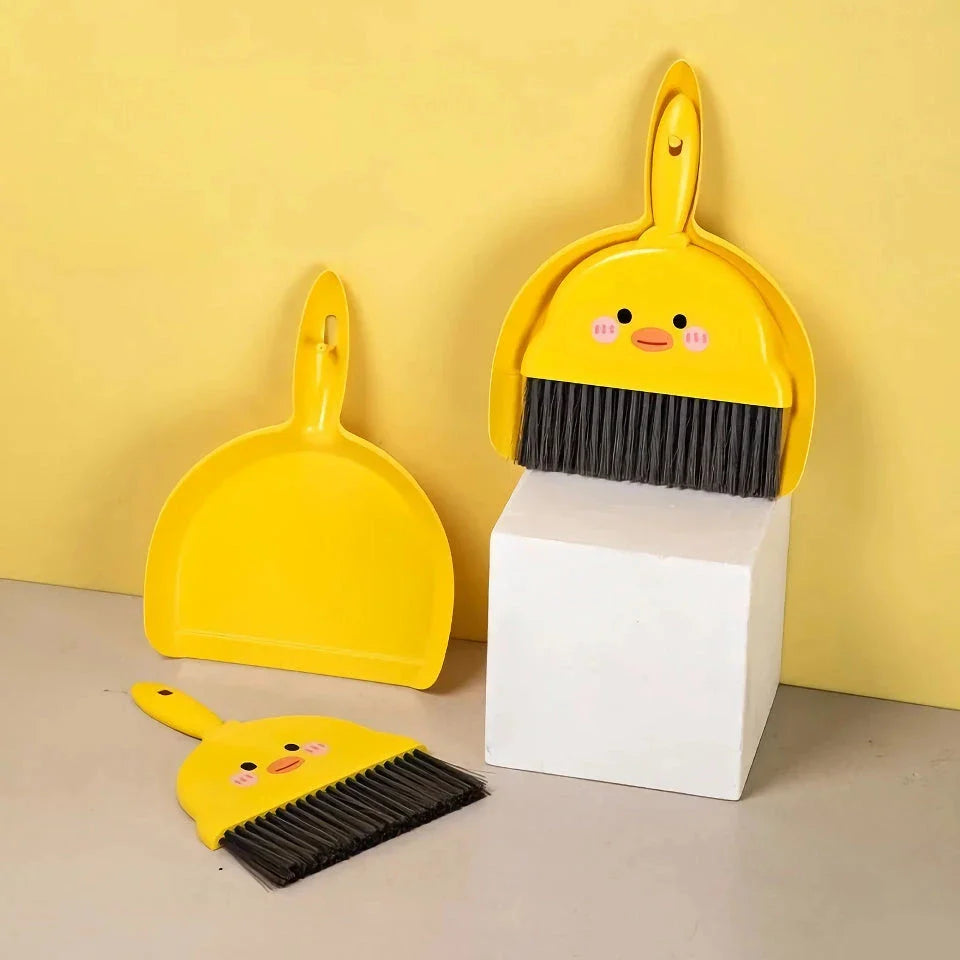 Compact table broom and dustpan set for children, featuring a yellow broom and dustpan made of durable materials for easy cleaning and tidying of small spaces.