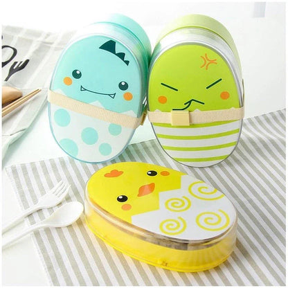 Egg-shaped children's lunch box in various colours, including black, green, blue, and yellow