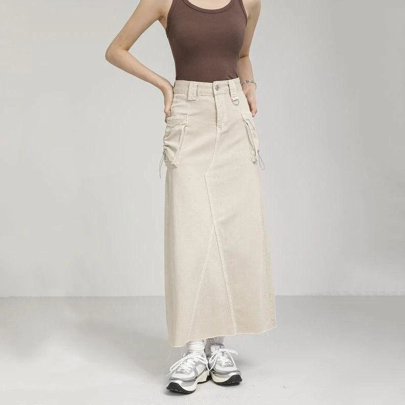 Elegant autumn vintage high-waist denim cargo skirt with pockets, featuring a flattering A-line silhouette and practical design