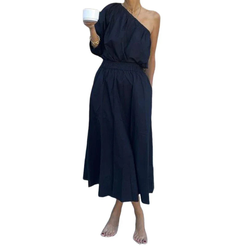 Elegant two-piece set with oblique shoulder blouse and midi skirt in black colour