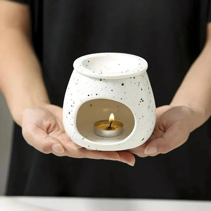 Elegant ceramic aroma diffuser with a unique spotted glaze design, perfect for creating a calming atmosphere in any room.