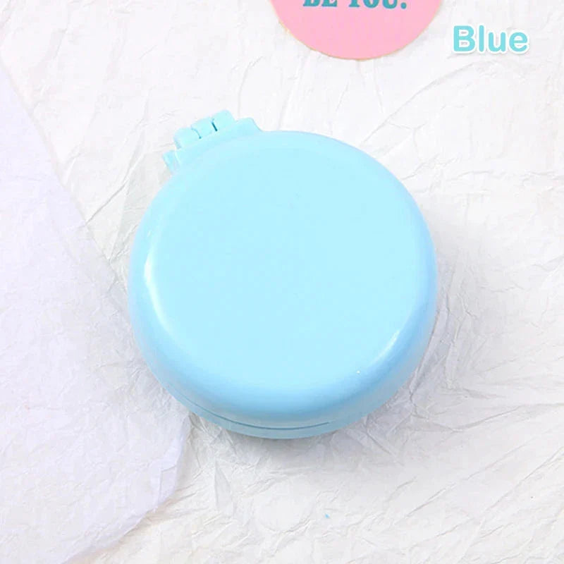 Portable folding hair comb with mirror, featuring a dual-sided design with a round mirror and eco-friendly hairbrush for on-the-go styling and grooming