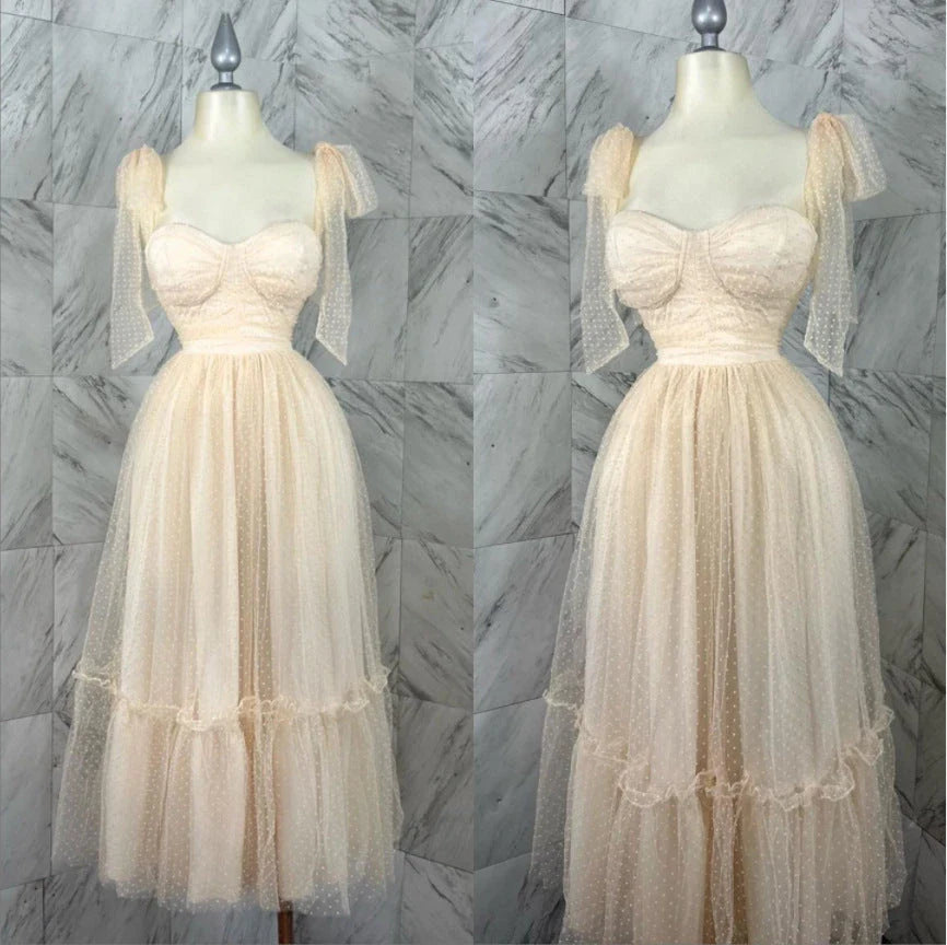 Enchanting fairy-style dress with flowing silhouette, delicate lace accents, and mid-length skirt in a classic black colour