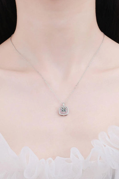 A rhodium-plated sterling silver necklace with a geometric pendant featuring a sparkling Moissanite gemstone over 0.3 carats.