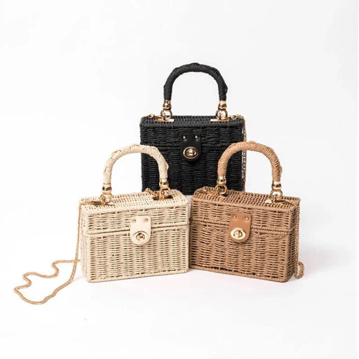 Handcrafted natural straw beach bag with bohemian-inspired design and detachable metal chain strap