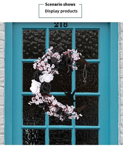 Spooktacular Halloween garland featuring a blend of dried white flowers, black roses, and mystical moon cat ornaments