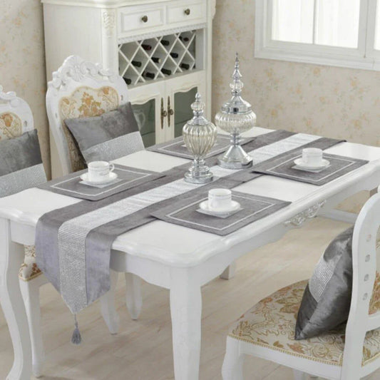 Elegant crystal-trimmed table runner with 4 coordinating beige placemats, creating a refined and sophisticated dining setting