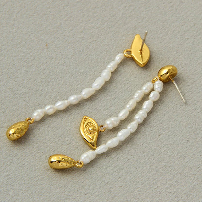 Pair of elegant, asymmetrical pearl earrings with a luxurious and sophisticated design