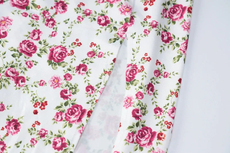 Elegant floral midi dress with slit, adjustable suspender straps, and luxurious polyester fabric for a sophisticated summer look.
