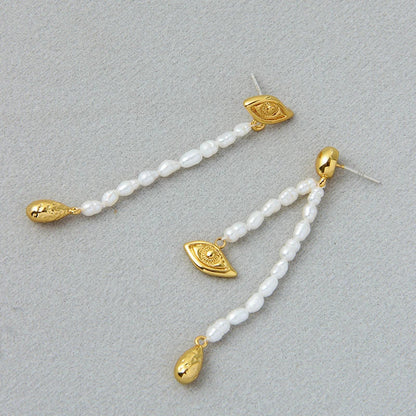 Pair of elegant, asymmetrical pearl earrings with a luxurious and sophisticated design