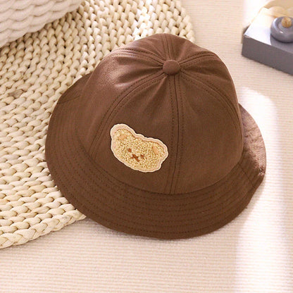 Cartoon Baby Hat in White Colour, Featuring a Playful Cartoon Pattern and Fitted Strap for a Comfortable Fit