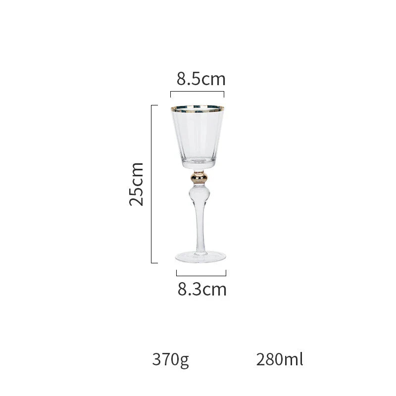 Elegant crystal wine glasses with refined gold vertical patterns, perfect for enjoying fine wines and champagne