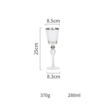 Elegant crystal wine glasses with refined gold vertical patterns, perfect for enjoying fine wines and champagne