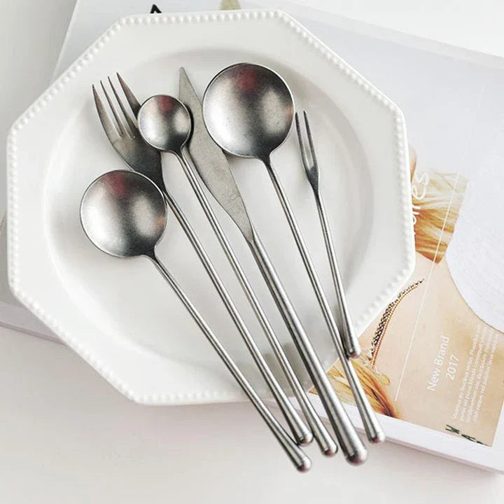 Elegant retro stainless steel cutlery set with sleek silver finish and solid pattern for sophisticated British dining