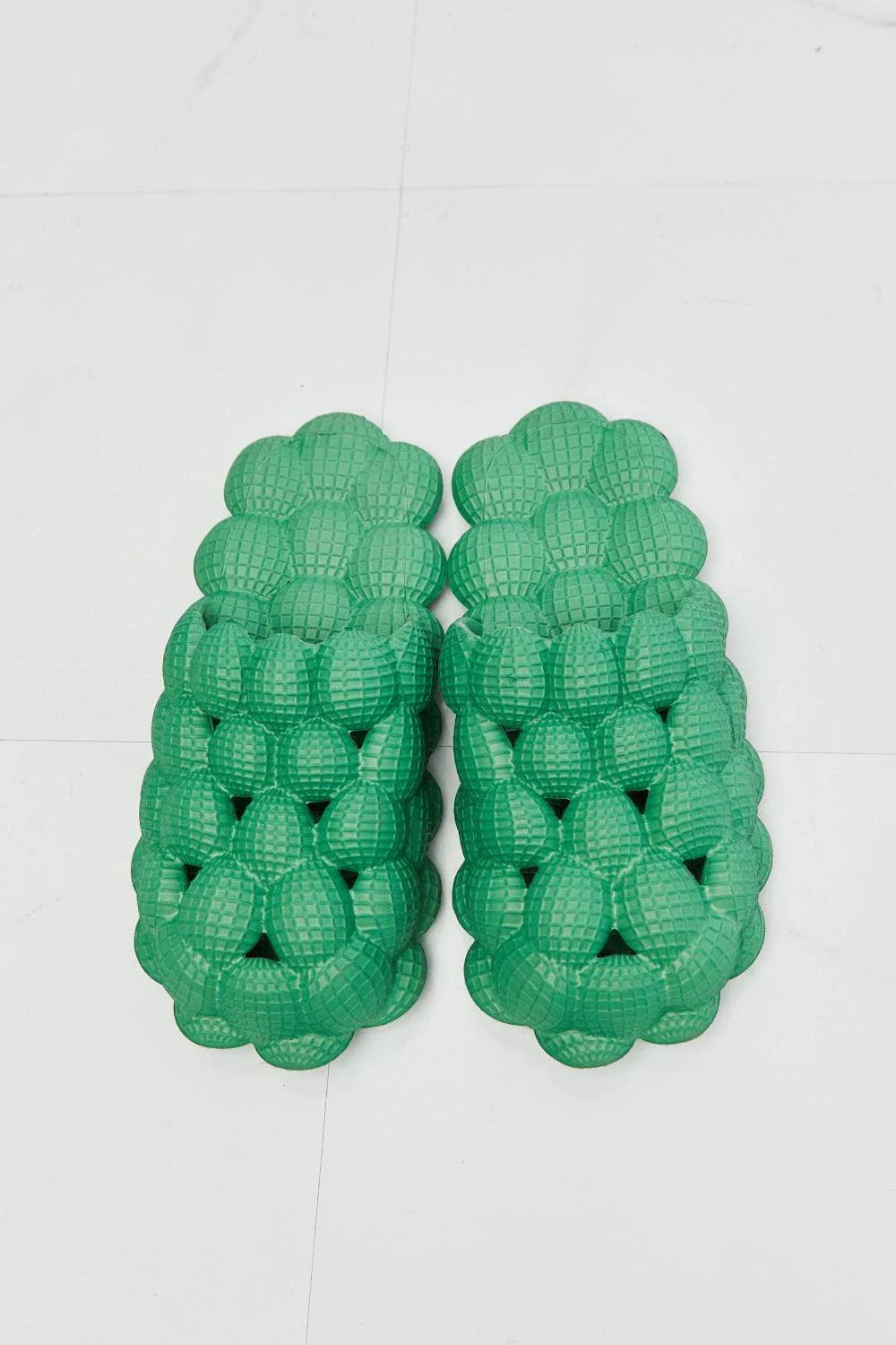 Cosy green bubble slide slippers with plush cushioning and slip-on design