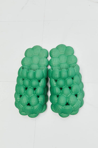 Cosy green bubble slide slippers with plush cushioning and slip-on design