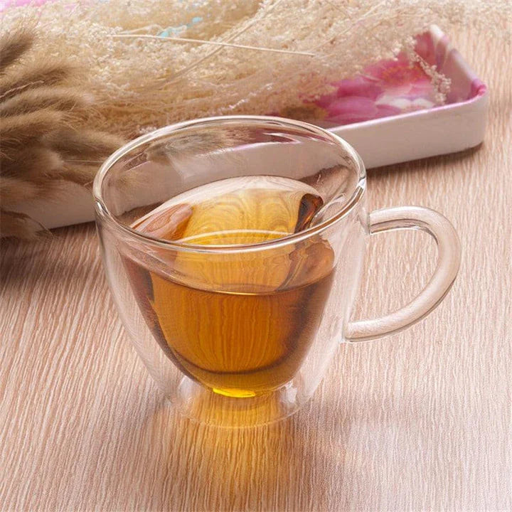 A charming heart-shaped ceramic mug with a smooth, glossy finish, perfect for enjoying hot beverages like tea or coffee.