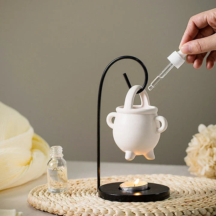 Captivating iron frame essential oil diffuser and candle holder with a unique witch's soup cup design