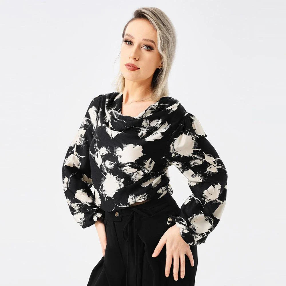 Elegant ladies' blouse with a printed pattern, dropped collar, and long sleeves in a classic white colour