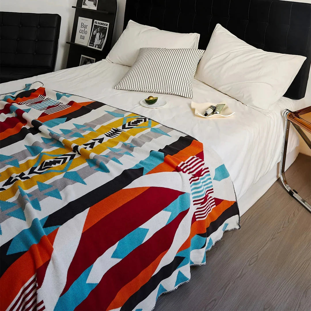 Cosy bohemian-style cotton blanket with vibrant geometric pattern, suitable for indoor and outdoor use