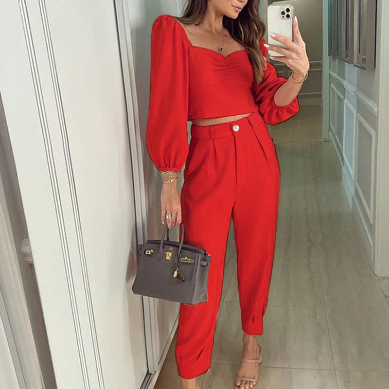 A stylish two-piece set with a square neckline top and ankle-tie trousers, made of premium polyester fabric and available in a range of vibrant solid colours.