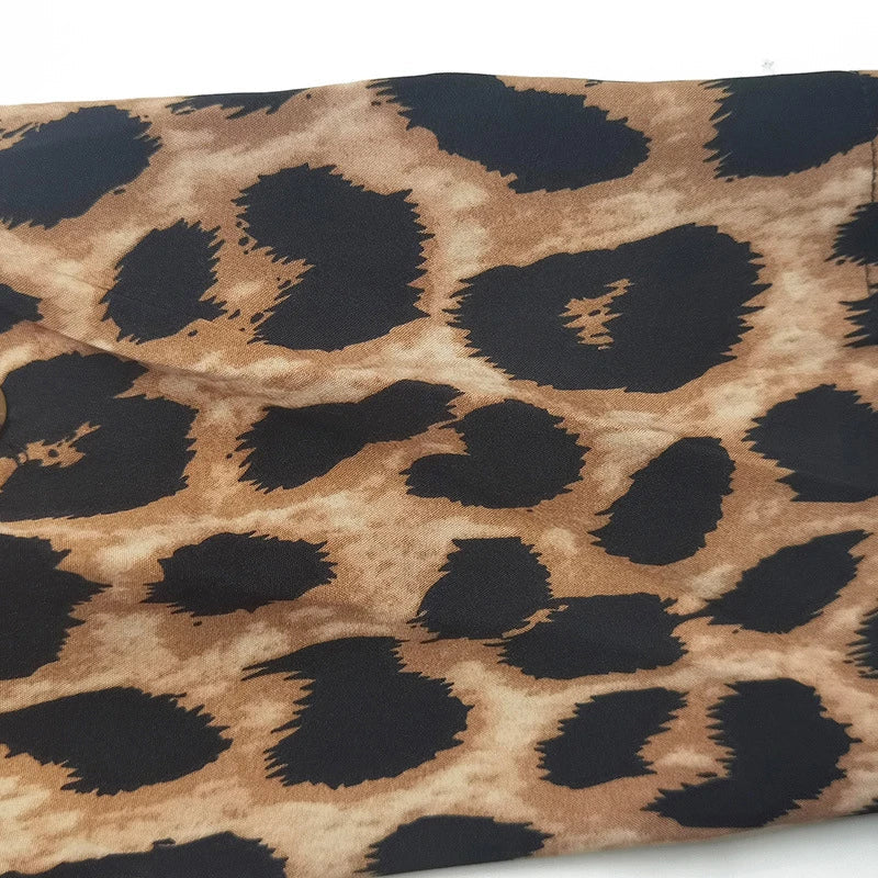 Elegant leopard print beach cover-up dress with A-line silhouette, loose waist, and pockets for comfortable and stylish holiday wear