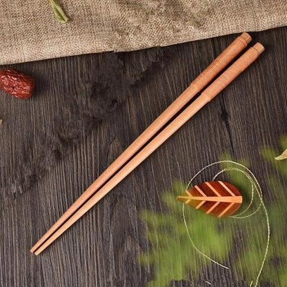 Pair of natural chestnut wood chopsticks with a rustic, earthy tone and elegant design