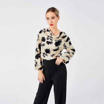 Elegant ladies' blouse with a printed pattern, dropped collar, and long sleeves in a classic white colour