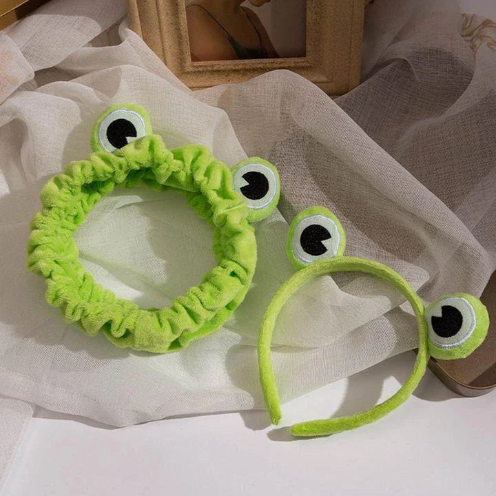 Charming frog-themed headband with plush coral fleece material and elastic band for a comfortable, customized fit