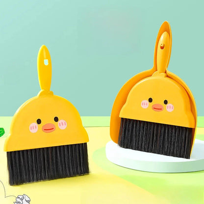 Compact table broom and dustpan set for children, featuring a yellow broom and dustpan made of durable materials for easy cleaning and tidying of small spaces.