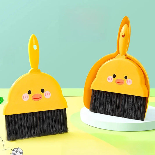 Compact table broom and dustpan set for children, featuring a yellow broom and dustpan made of durable materials for easy cleaning and tidying of small spaces.