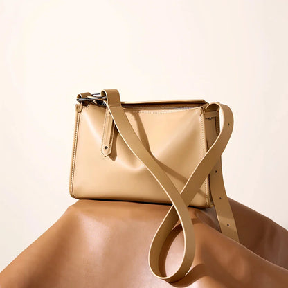 Genuine leather shoulder bag with soft, pillow-like shape and secure zipper closure