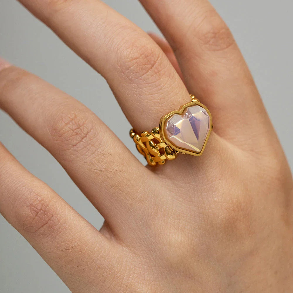 Adjustable stainless steel ring with a mermaid-inspired heart design and shell beads, a unique and versatile accessory.