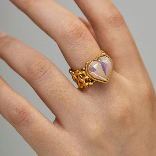 Adjustable stainless steel ring with a mermaid-inspired heart design and shell beads, a unique and versatile accessory.
