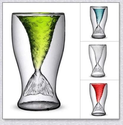 A transparent glass mug with a decorative mermaid tail design, perfect for enjoying a range of beverages in style.