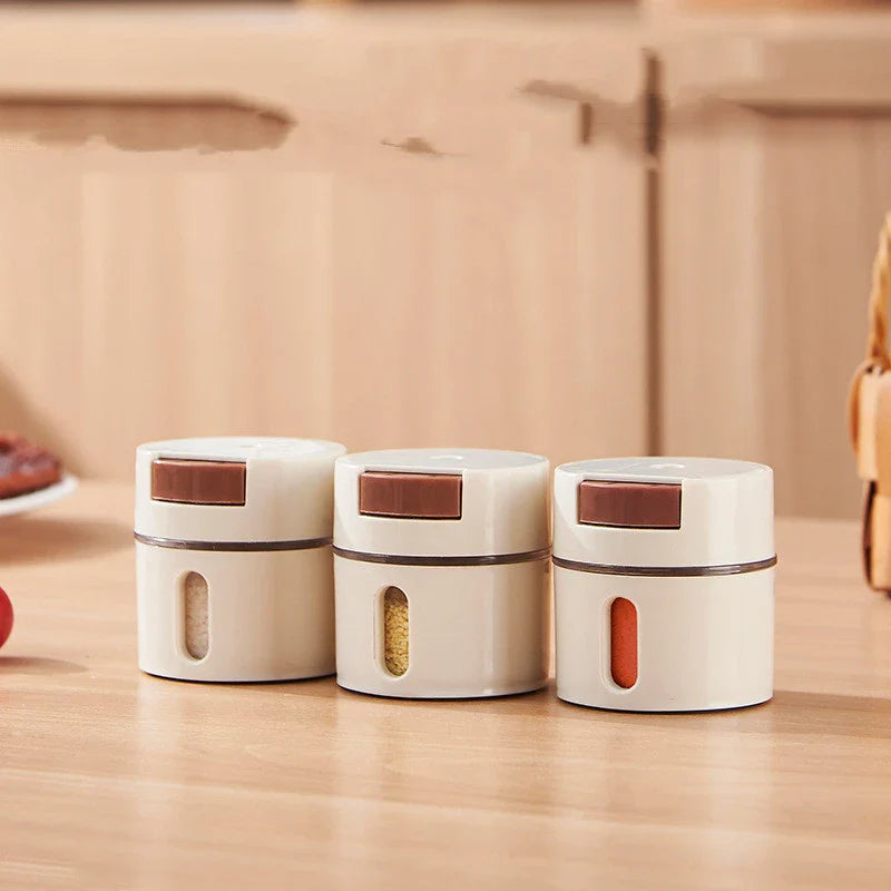A modern, wall-mounted glass salt dispenser with magnetic suction and precise quantitative control for effortless kitchen organisation.