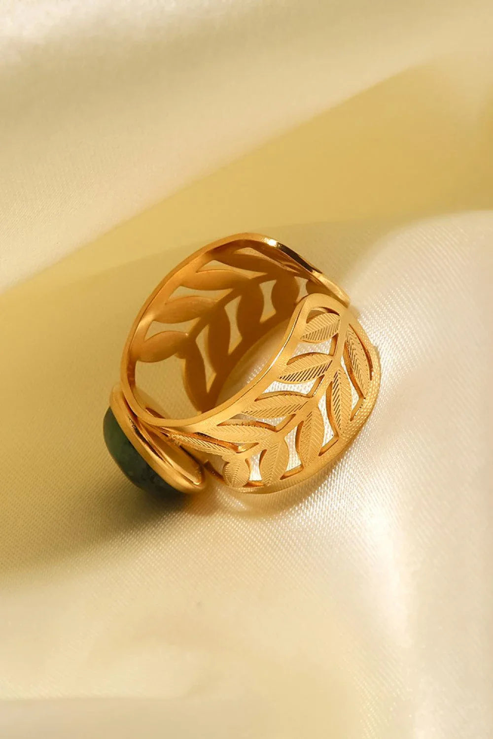 Elegant 18K gold-plated malachite leaf ring in a flat lay, studio style photograph
