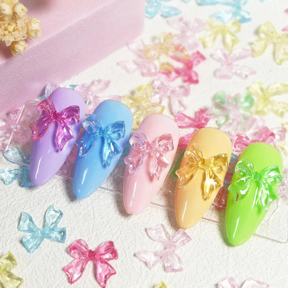 Charming candy-coloured bow nail charms in various colours, perfect for adding a playful touch to your manicure