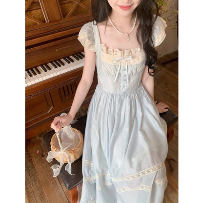 Elegant lace-trimmed blue maxi dress with high-waisted silhouette and sleeveless design