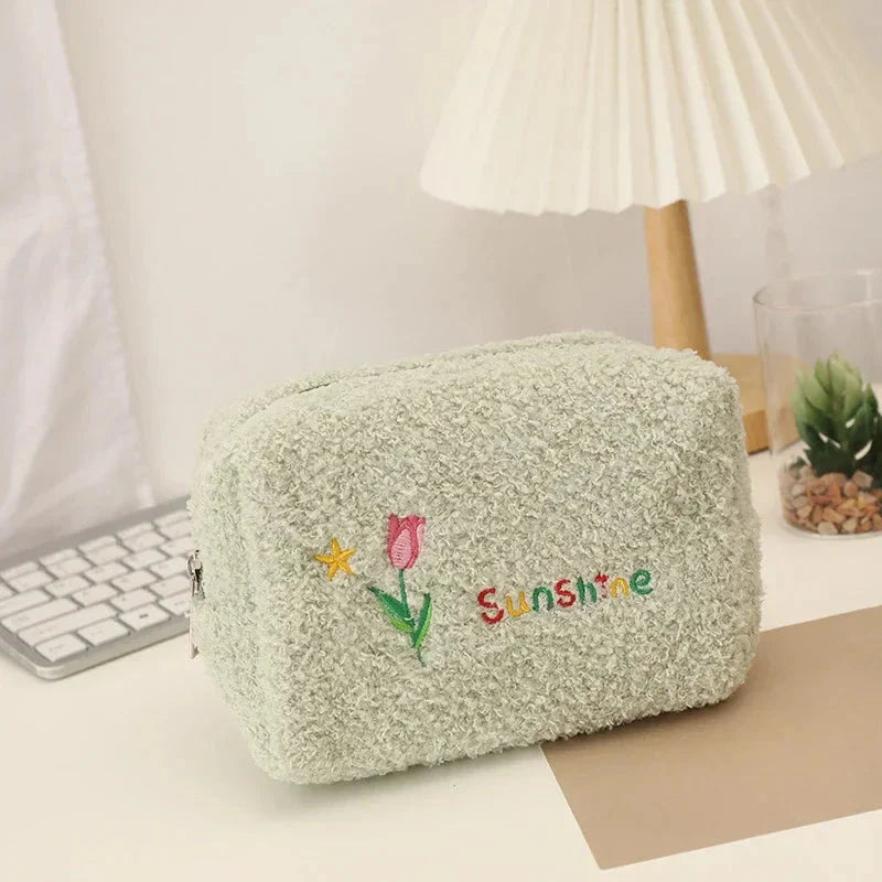 Elegant embroidered flowers cosmetic pouch made of soft, plush material in ivory colour