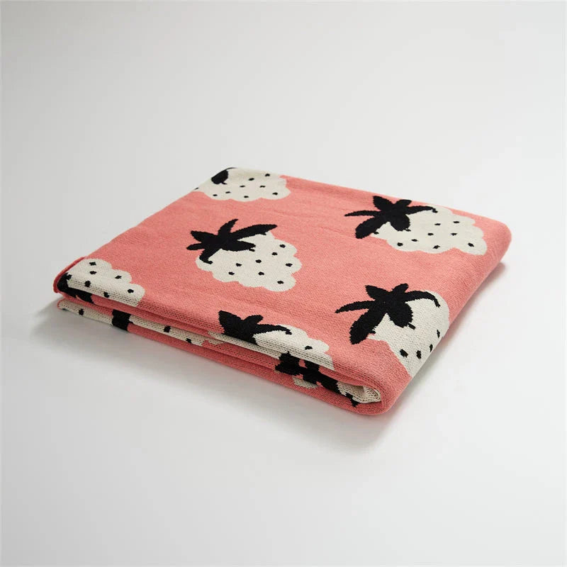 A cosy grape-patterned cotton blanket with a sophisticated design, perfect for relaxation and home decor