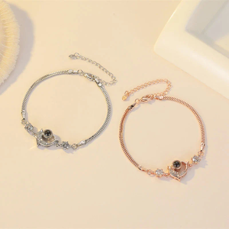 Couple wearing vibrant, projection couple bracelets in rose gold and platinum finishes