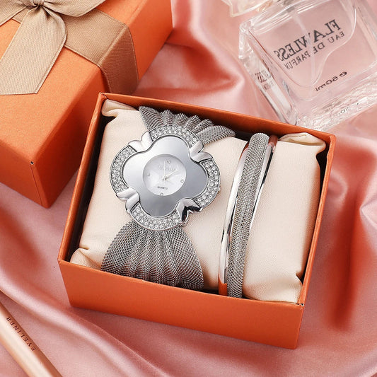 Elegant women's wrist watch with a floral dial design and a gleaming gold and silver mesh strap